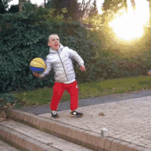 a young boy is holding a basketball that says ' nb ' on it