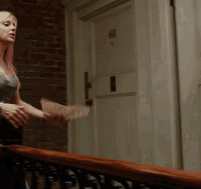 a woman is standing in front of a door with a sticker on it that says ' a ' on it