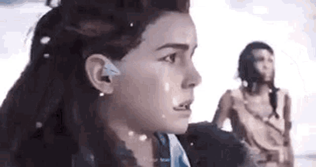 two women are standing next to each other in a video game .