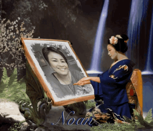 a woman in a blue kimono is holding a framed picture of herself and the name noam is on the bottom right