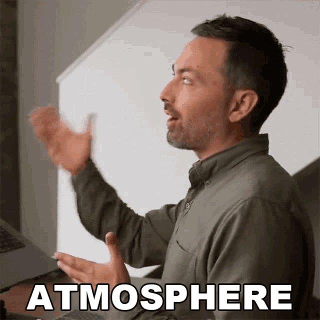 a man with his arms outstretched and the word atmosphere above him