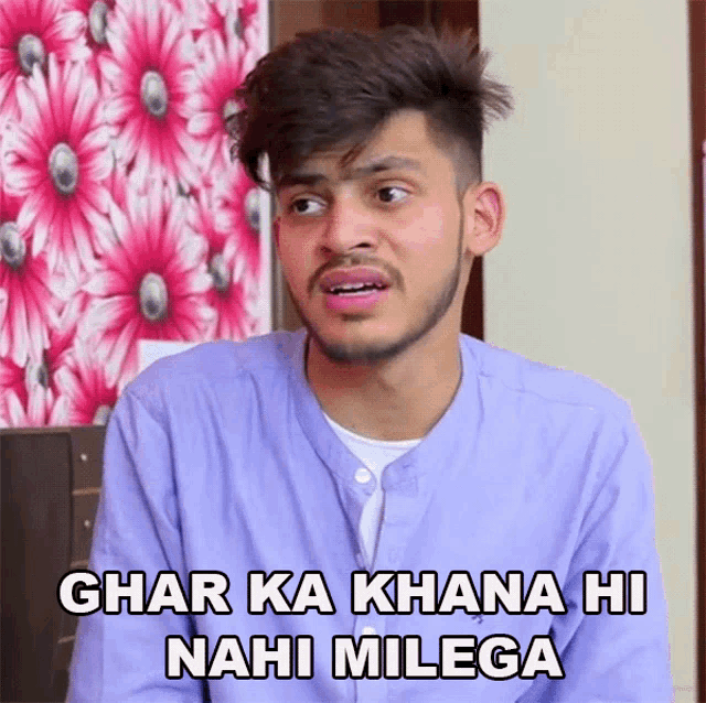 a man in a purple shirt says char ka khana hi nahi milega in front of flowers