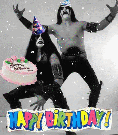 a man and a woman wearing party hats are standing next to a birthday cake that says happy birthday