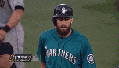 a baseball player in a marines jersey is talking to another player