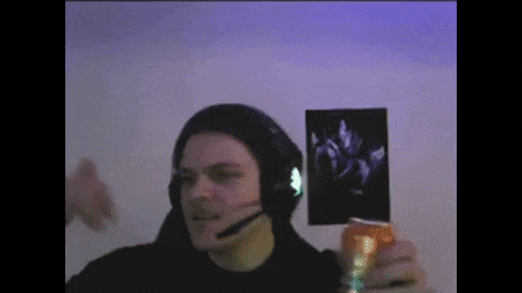 a man wearing headphones and a microphone is holding a can of soda and a picture .