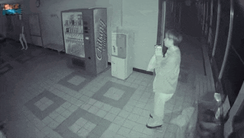 a person standing in front of a vending machine that says rising