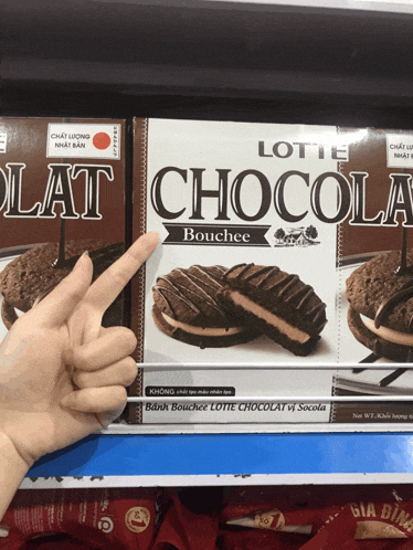 a person points to a box of lotte chocola bouchee cookies