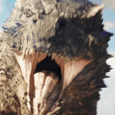 a close up of a monster 's mouth with a blue sky in the background