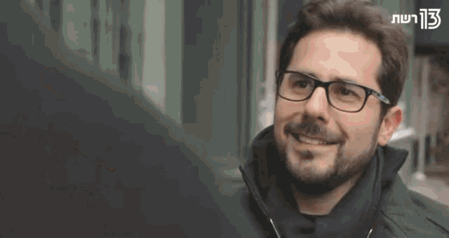 a man with glasses is talking to another man in a foreign language