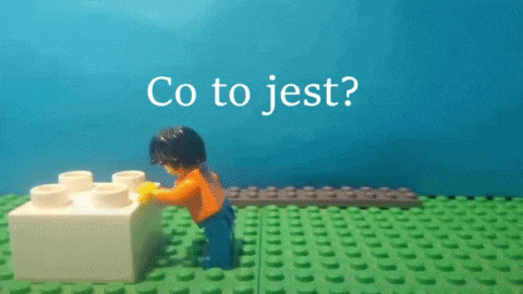 a lego man standing next to a white block with the words " co to jest " written on it
