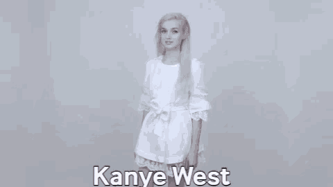 a woman in a white dress is standing in front of a white background and says `` kanye west '' .