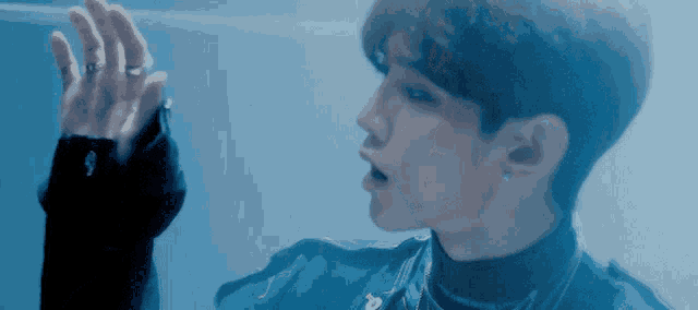 a close up of a person 's face with a blue background .