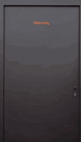 two men are standing next to each other in a doorway .