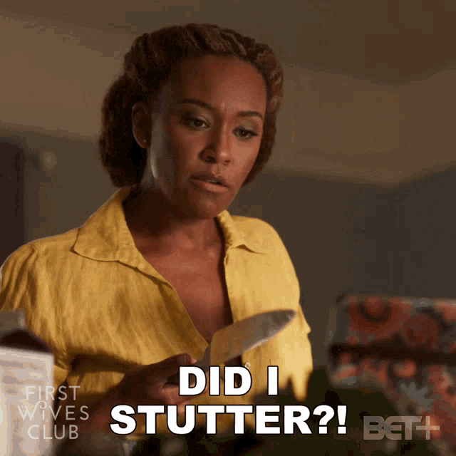 a woman in a yellow shirt is holding a piece of paper and says " did i stutter "