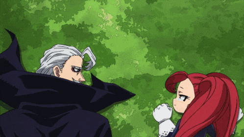 a man and a girl with red hair are standing next to each other in front of a green background