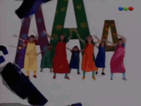 a group of people are standing in front of a large letter a