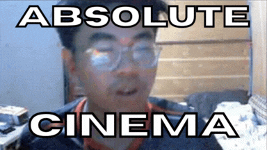 a man with glasses and the words absolute cinema