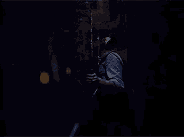a woman is standing in front of a mirror in a dark room .