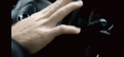 a close up of a person 's hand on the steering wheel