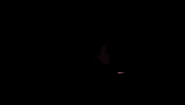 a red and white light is coming out of a dark room