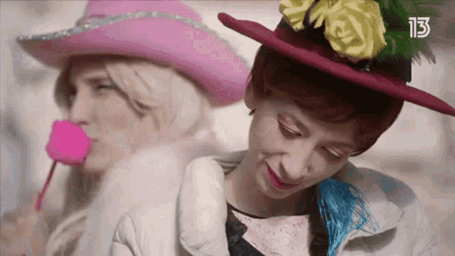 a woman wearing a pink hat with the number 13 on the bottom right