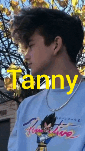a young man is wearing a blue shirt with the name tanny on it