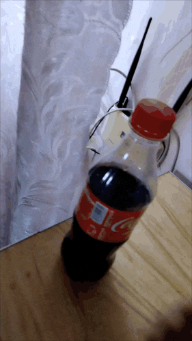 a bottle of coca cola is sitting on a table