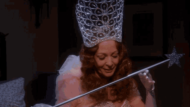 a woman dressed as a fairy holding a wand