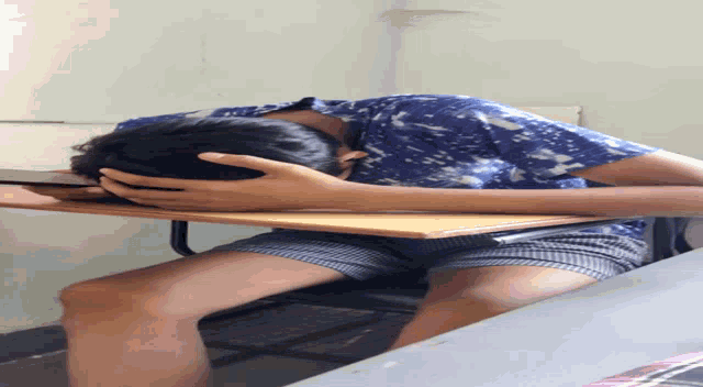 a person laying on their back with their head on a chair