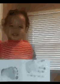 a child is holding a piece of paper with footprints on it in front of a window