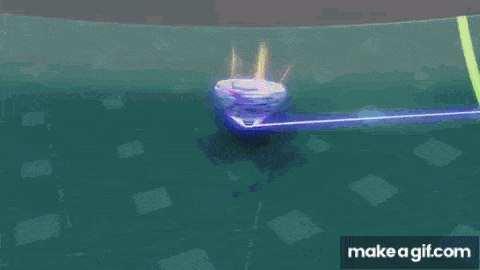 a purple and yellow spinning top is spinning on a green and blue field .