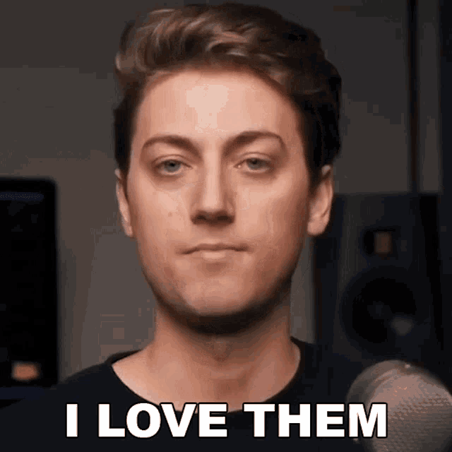 a man is holding a microphone and says i love them .