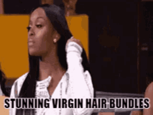 a woman with long hair is sitting in front of a sign that says " stunning virgin hair bundles " .