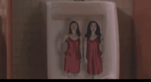 a urinal with a picture of two women in red dresses