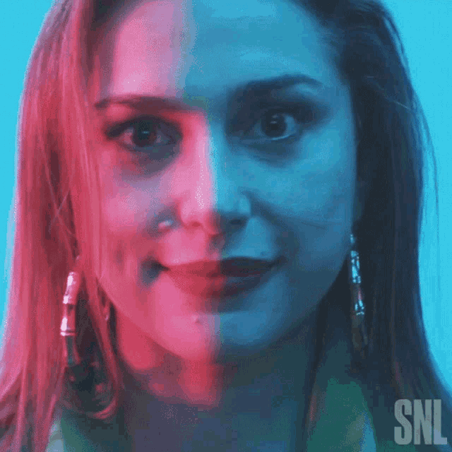 a close up of a woman 's face with a snl logo in the corner