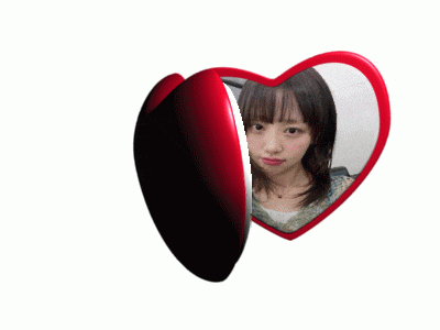 a heart shaped mirror with a woman 's face in it