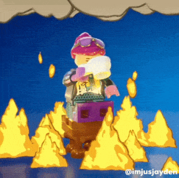 a lego figure is standing in front of a fire .