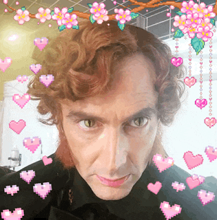 a man with hearts and flowers around his head