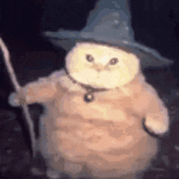a cat wearing a witch hat and holding a wand .