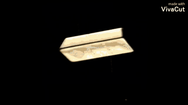 a large gold bar is sitting on a black background .