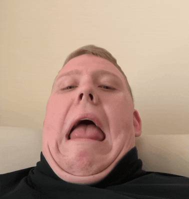a man with his tongue out making a funny face
