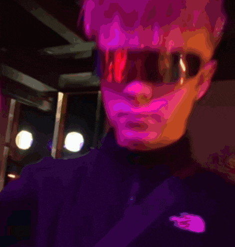 a person with a pink face and glasses on