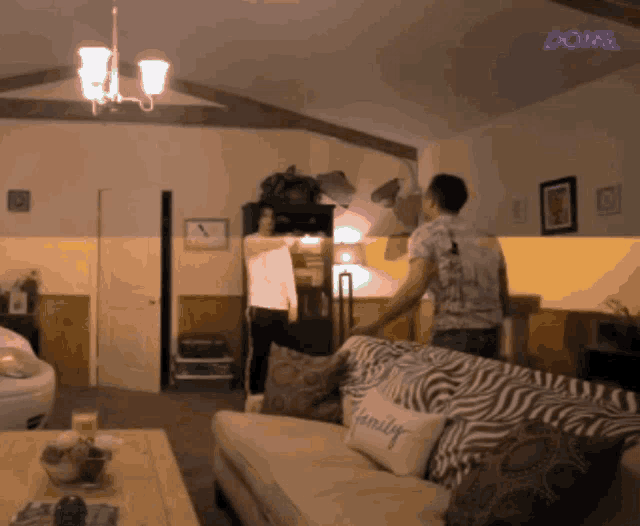 a living room with a couch that has a pillow that says family