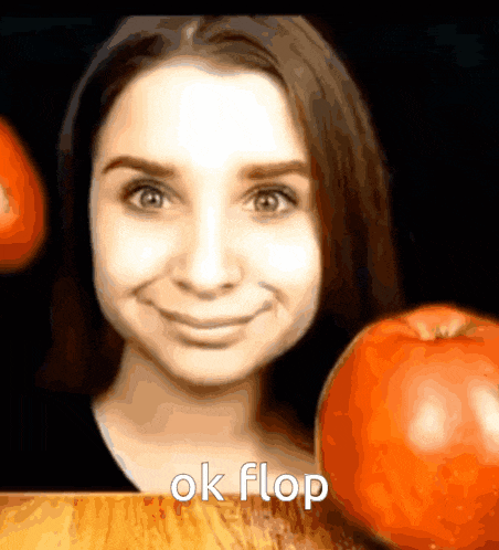 a woman is smiling next to an apple with the words ok flop written below her