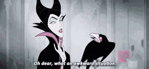 maleficent from sleeping beauty is standing next to a black bird .
