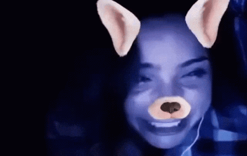 a woman is wearing a dog face mask on her face .