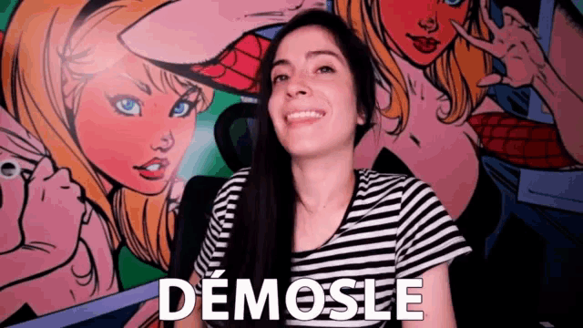 a woman is smiling in front of a painting that says demose