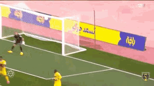 a group of soccer players are playing a game on a field with advertisements on the sidelines .