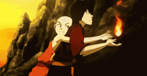 a boy and a girl are standing next to each other holding a fireball in their hands .