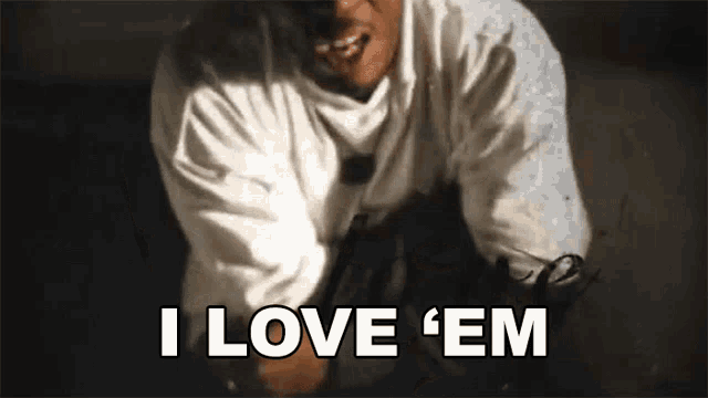 a man in a white shirt is saying `` i love em '' .